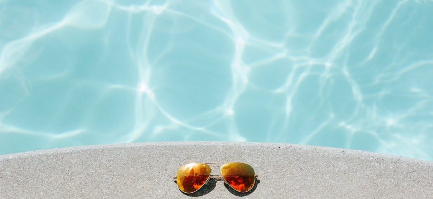 pool with sunglasses on the ledge