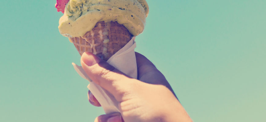 Gelato,Ice,Cream,Cone,Held,Up,To,The,Hot,Summer