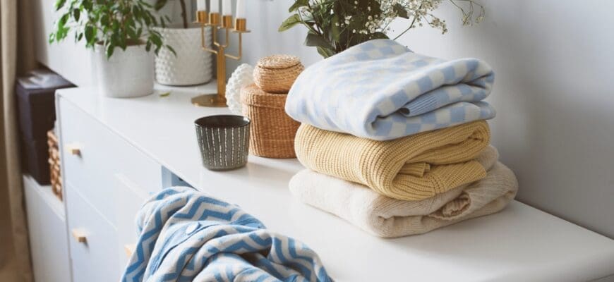 White,Scandi,Drawer,With,Stack,Of,Patterned,Knitted,Sweaters.,Spring